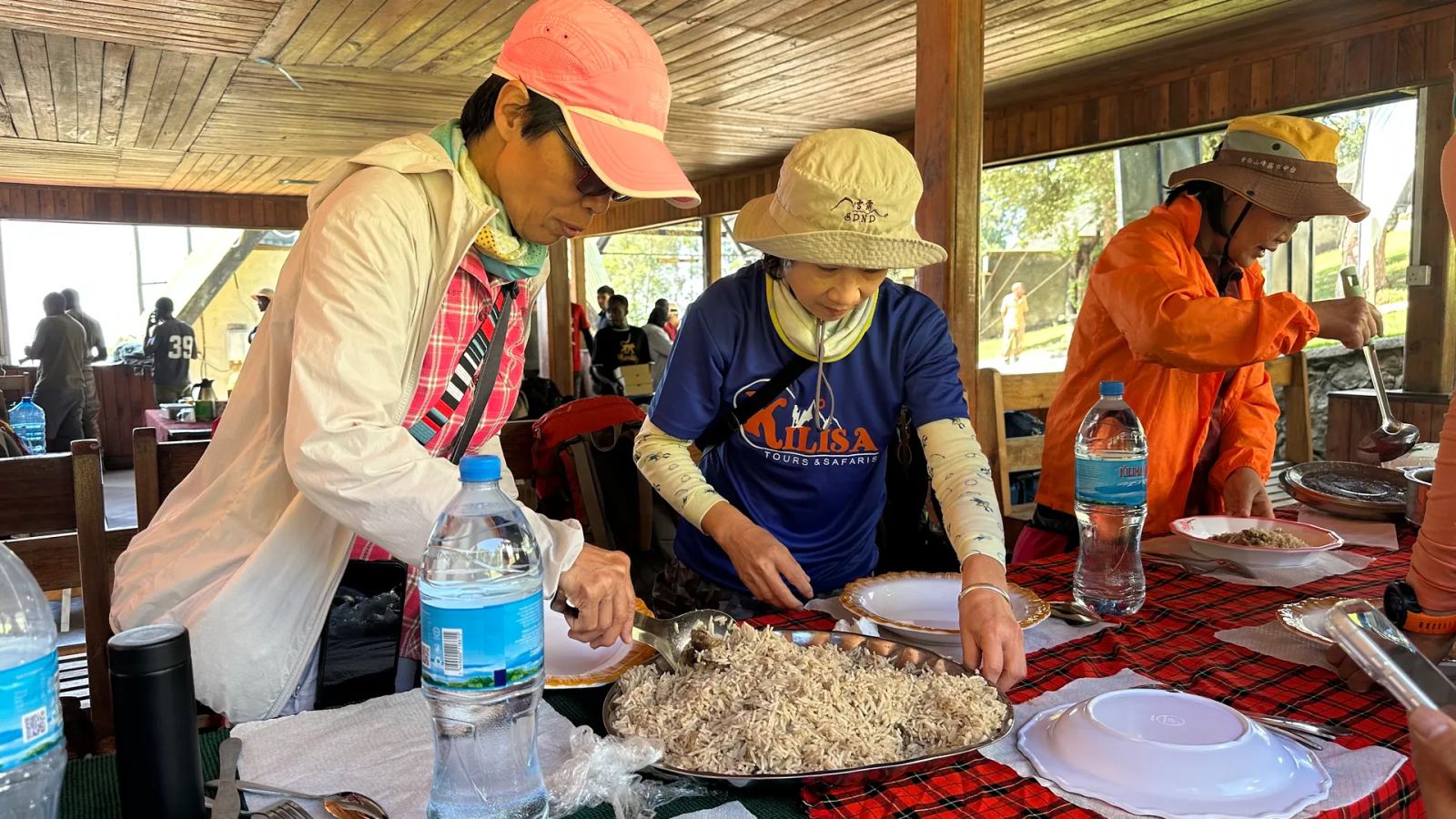 Trekkers serving lunch at the Machame Gate dining shelter before starting their Kilimanjaro climb