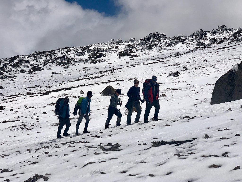 Line of climbers crossing a snowy slope on Kilimanjaro